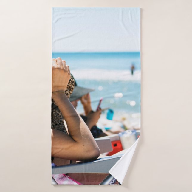 Woman lying on sun lounger covering her face with  bath towel (Bath Towel)