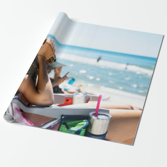Woman lying on sun lounger covering her face with  wrapping paper (Unrolled)