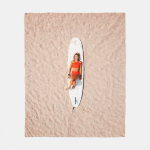 Woman lying on the surfboard fleece blanket