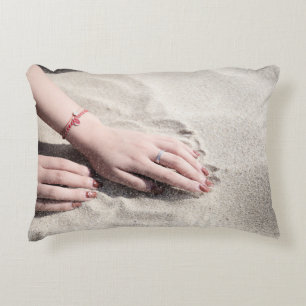 Woman lying on white sand decorative cushion
