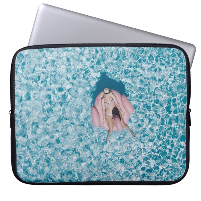 Woman on pink buoy surrounded by body of water in  laptop sleeve (Front)