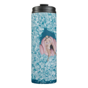 Woman on pink buoy surrounded by body of water in thermal tumbler