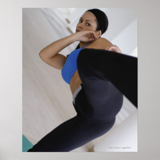 Woman performing martial arts poster