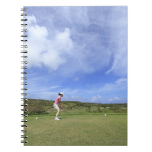 Woman playing golf spiral notebook