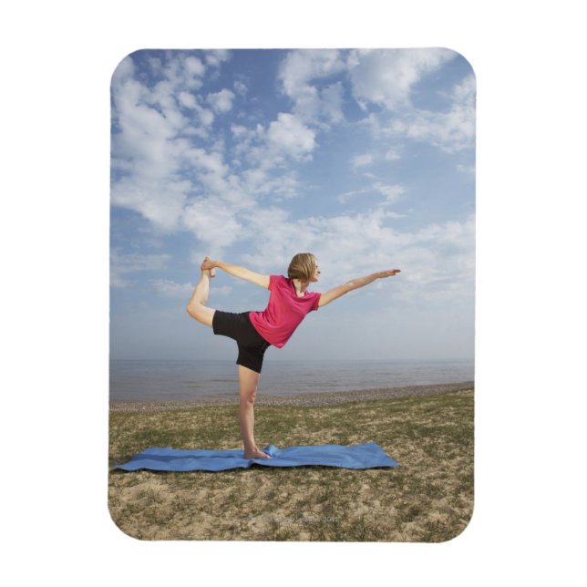 Woman practicing yoga by the beach magnet (Vertical)