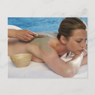 Woman receiving spa treatment, side view, close postcard