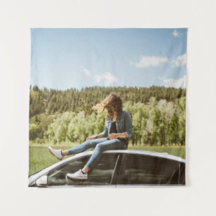 Woman sitting on roof of white sedan tapestry