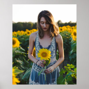 Woman standing at sunflower field poster