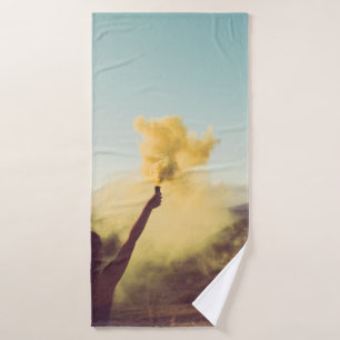 Woman standing on desert holding flare bath towel