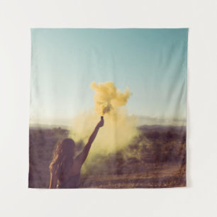 Woman standing on desert holding flare tapestry