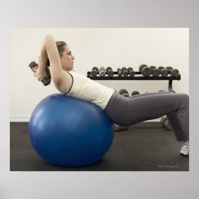 Woman using exercise ball and hand weights poster (Front)