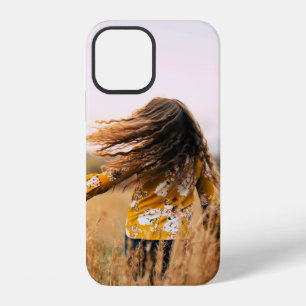 Woman walking on field at daytime iPhone 12 case