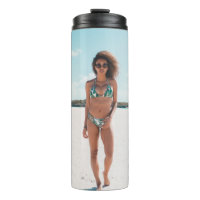 Woman wearing bikini standing on sand