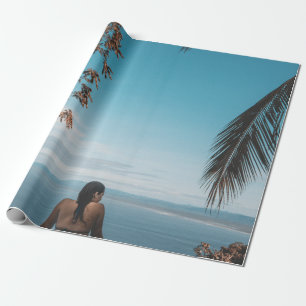 Woman wearing black bikini tap swimming on body of wrapping paper