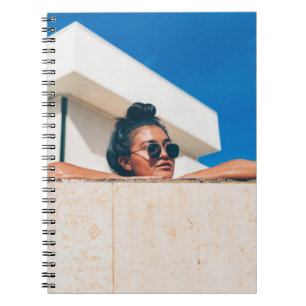 Woman wearing black sunglasses notebook