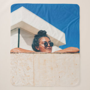 Woman wearing black sunglasses sherpa blanket