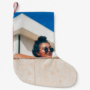 Woman wearing black sunglasses small christmas stocking