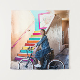 Woman wearing blue denim jacket and shorts riding tapestry