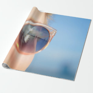 Woman wearing brown framed sunglasses wrapping paper