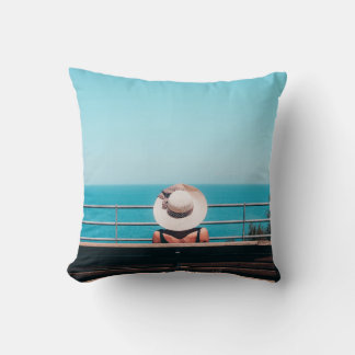 Woman wearing white straw hat sitting on bench loo cushion