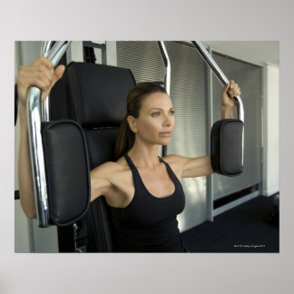 Woman working out in a gym poster