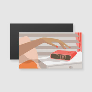 Womans hand pushing on alarm clock snooze button