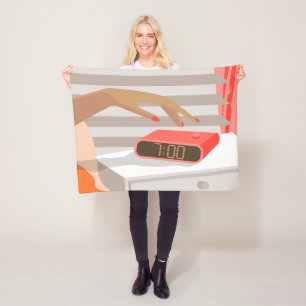 Womans hand pushing on alarm clock snooze button fleece blanket