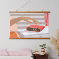 Womans hand pushing on alarm clock snooze button