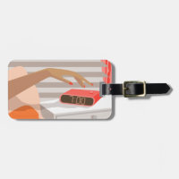 Womans hand pushing on alarm clock snooze button