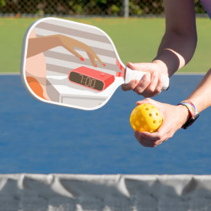 Womans hand pushing on alarm clock snooze button pickleball paddle