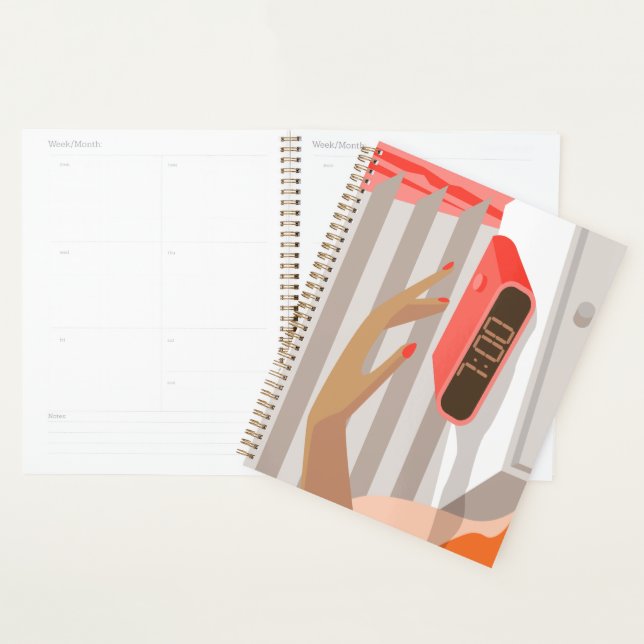 Womans hand pushing on alarm clock snooze button planner (Display)