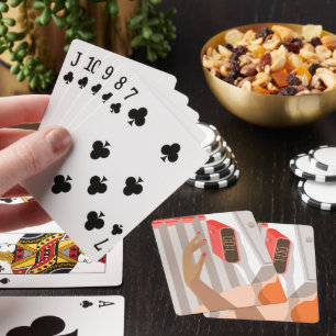 Womans hand pushing on alarm clock snooze button playing cards