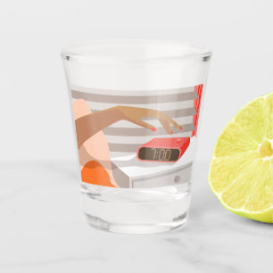 Womans hand pushing on alarm clock snooze button shot glass