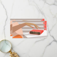 Womans hand pushing on alarm clock snooze button