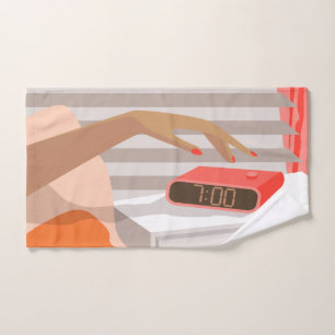 Womans hand pushing on alarm clock snooze button towel