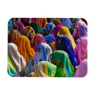 Women in colourful saris gather together magnet