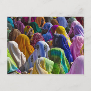 Women in colourful saris gather together postcard