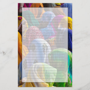 Women in colourful saris gather together stationery