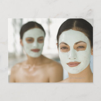 Women smiling in beauty mud masks postcard