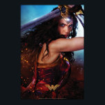 Wonder Woman Blocking With Sword Poster<br><div class="desc">Check out Wonder Woman,  as played by Gal Gadot,  fighting on the battlefield and blocking with her sword held above her head and along her back. Wonder Woman's tiara glows with power as she gives a fierce glare.</div>