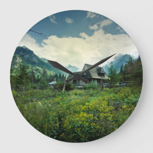 Wooden house, mountain nature scenery. large clock