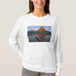 Wooden kayak in Swiftcurrent Lake at sunrise in T-Shirt
