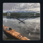 Wooden kayak on shore of Beaver Lake Square Wall Clock<br><div class="desc">Chuck Haney / DanitaDelimont.com | USA,  North America,  Montana | Wooden kayak on shore of Beaver Lake near Whitefish,  Montana,  USA.</div>