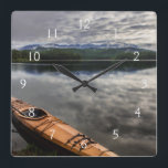 Wooden kayak on shore of Beaver Lake Square Wall Clock<br><div class="desc">Chuck Haney / DanitaDelimont.com | USA,  North America,  Montana | Wooden kayak on shore of Beaver Lake near Whitefish,  Montana,  USA.</div>