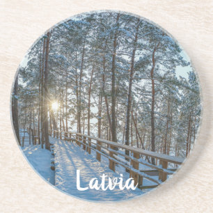 Wooden path across snowy winter forest coaster