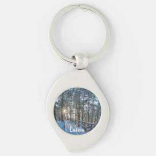 Wooden path across snowy winter forest key ring