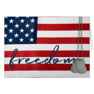 word freedom and dog tags on flag