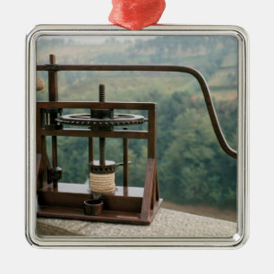 Working model of an olive press metal tree decoration