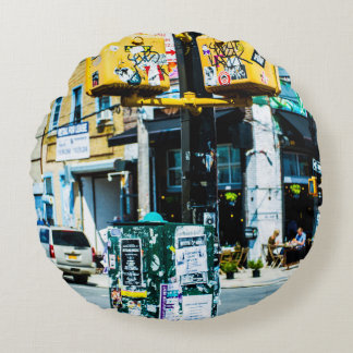 YELLOW AND BLACK POST FILLED WITH FLYERS ROUND CUSHION