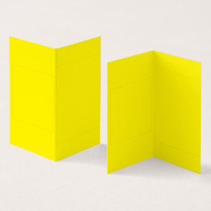 Yellow and orange abstract shapes overlap on a pla